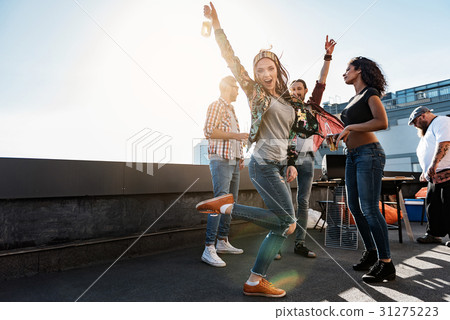 Carefree girl enjoying party on rooftop terrace 31275223