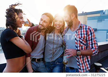 Joyful friends having party on roof Joyful friends having party on roof 31275225