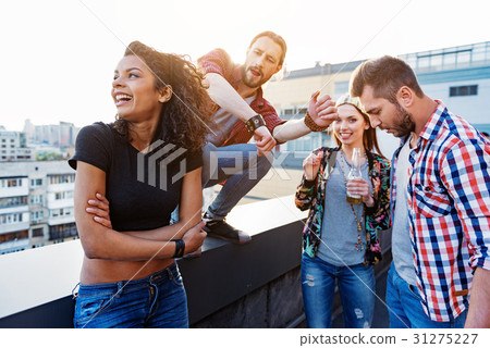 Excited friends having fun on roof 31275227