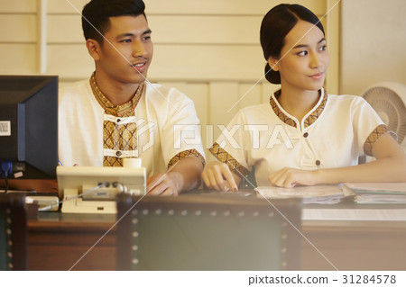 a portrait of two receptionists in reception desk. 31284578