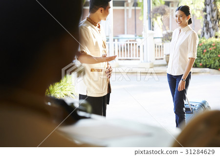 a guest is welcomed by a male receptionist. a guest is welcomed by a male receptionist. 31284629