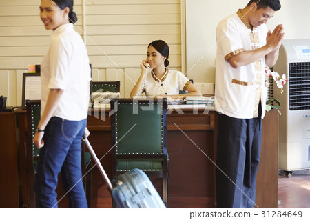 a photo of a guest, two receptionists calling and welcoming a photo of a guest, two receptionists calling and welcoming 31284649