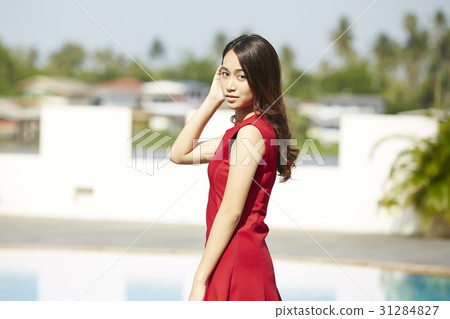 A photo of beautiful girl standing next to a poolside A photo of beautiful girl standing next to a poolside 31284827