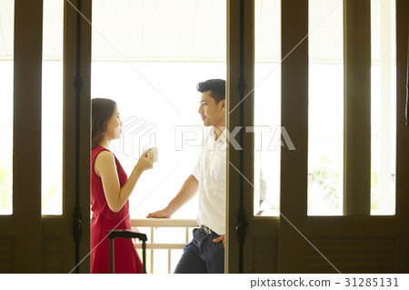the couple is standing outside balcony and talking 31285131