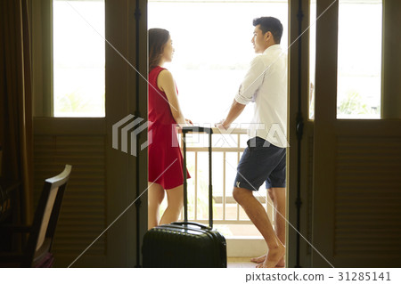 the couple is talking outside the balcony of a hotel room the couple is talking outside the balcony of a hotel room 31285141