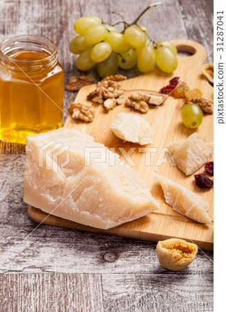 Honey, grape, different type of cheese and nuts on Honey, grape, different type of cheese and nuts on 31287041