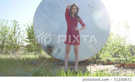 Strict girl. A serious girl stands near a barrel 31288651