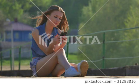 The girl is holding a smartphone. Internet girl The girl is holding a smartphone. Internet girl 31288816