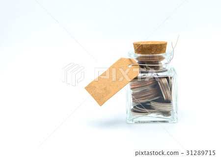 bottle of coins, with blank paper tag on white  31289715