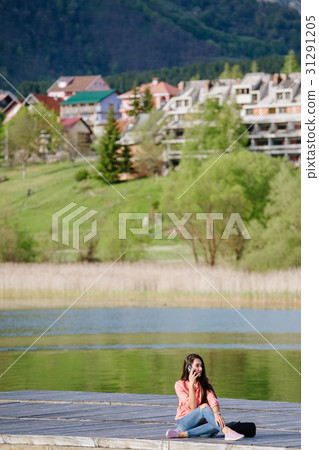 woman with smartphone backpacking in mountains woman with smartphone backpacking in mountains 31291205