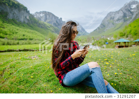 woman with smartphone backpacking in mountains woman with smartphone backpacking in mountains 31291207