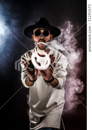Man making smoke ring with vape Man making smoke ring with vape 31291673