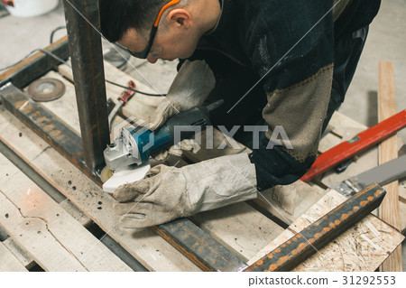 Man doing electroshooting of parts on the steel Man doing electroshooting of parts on the steel 31292553