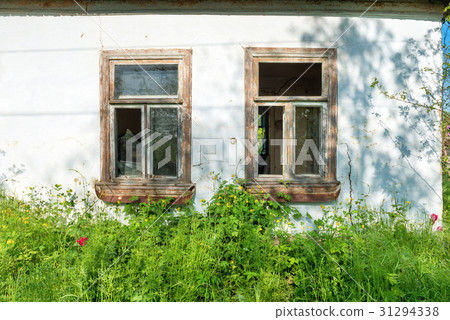 Broken glass windows in a house 31294338