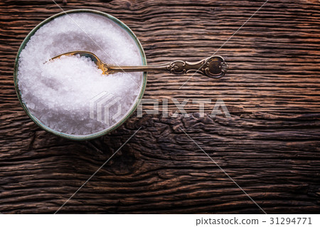 Sea salt retro fork in bowl on rustic oak table. Sea salt retro fork in bowl on rustic oak table. 31294771