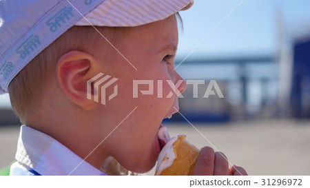 the child eats a waffle cup ice cream in park at 31296972