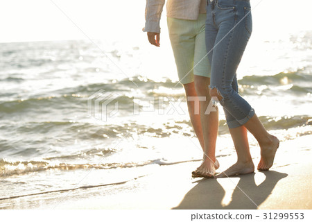 Legs of couple on the sand beach Legs of couple on the sand beach 31299553