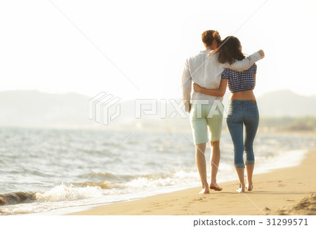 happy couple waling on the beach and having fun happy couple waling on the beach and having fun 31299571