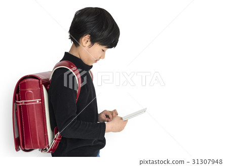 Young asian kid with a backpack using a tablet isolated portrait Young asian kid with a backpack using a tablet isolated portrait 31307948