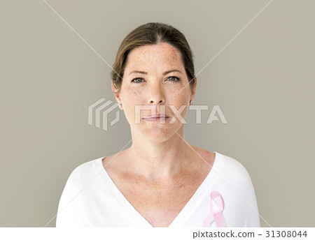Woman with pink ribbon for breast cancer awareness charity studio portrait Woman with pink ribbon for breast cancer awareness charity studio portrait 31308044