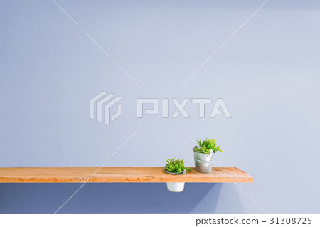 Wooden shelf on purple vintage wall with plant. 31308725