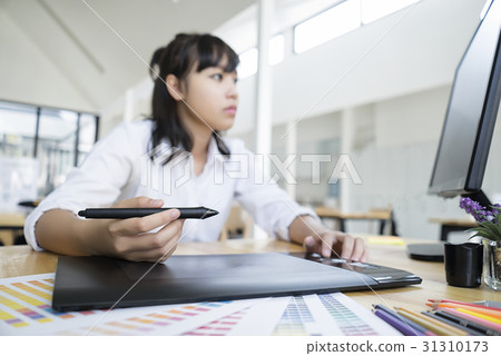 Graphic designer using graphics tablet computer 31310173