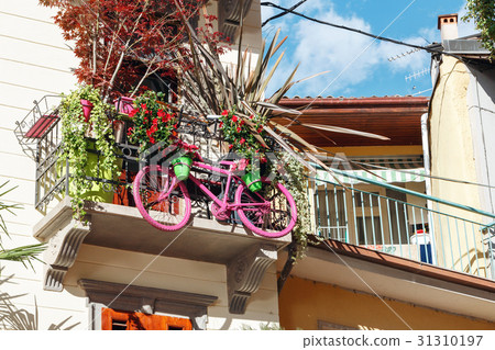 pink Bicycle hanging on the balcony and used for pink Bicycle hanging on the balcony and used for 31310197