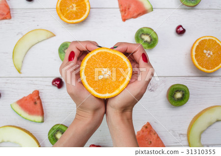 Top view of girl's hands, placed on white desktop 31310355