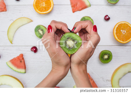 Top view of girl's hands, placed on white desktop 31310357