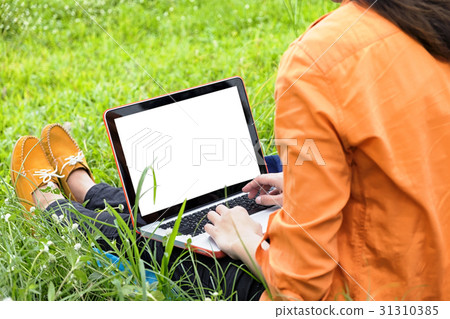 young woman sit on green grass enjoy the music 31310385