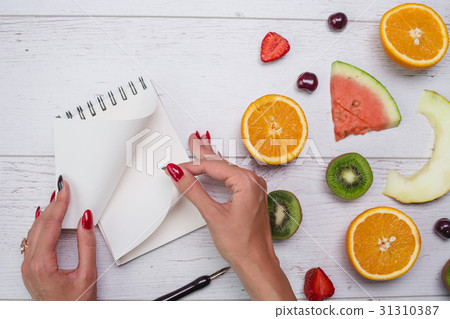 Top view of girl's hands, placed on white desktop 31310387