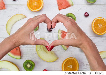 Top view of girl's hands, placed on white desktop 31310428