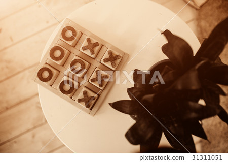 Tic-tac-toe game in stone box on the table for 31311051