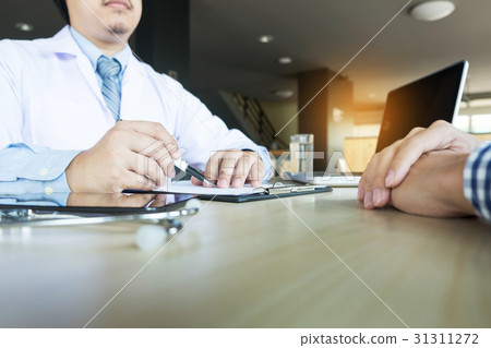 patient listening intently to doctor explaining 31311272