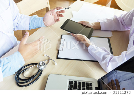 Two doctors discussing patient notes 31311273