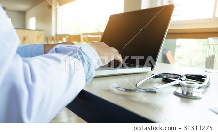 male doctor sitting at the table 31311275