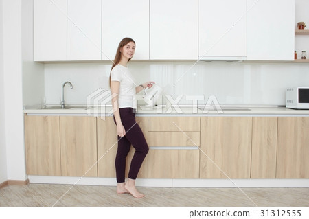 Portrait of Young adult brunette woman making tea Portrait of Young adult brunette woman making tea 31312555