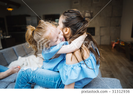 Elder and younger daughter on the big couch 31312936