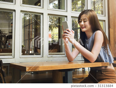 Asian women use smartphone in cafe shop. 31313884