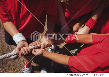 Kids playing tug of war during obstacle course 31313956