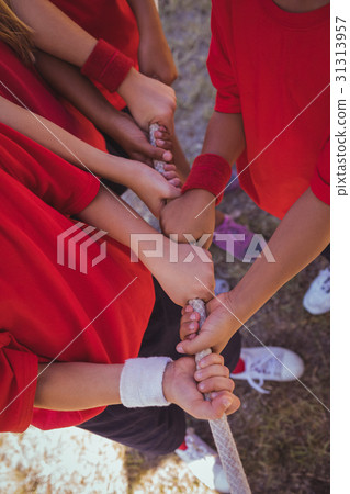 Kids playing tug of war during obstacle course  31313957