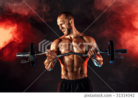 Strong sportsman lifting heavy dumbbell in smoke Strong sportsman lifting heavy dumbbell in smoke 31314342