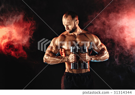 Strong sportsman lifting heavy dumbbell in smoke Strong sportsman lifting heavy dumbbell in smoke 31314344