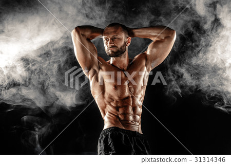 Professional bodybuilder posing with arms on head Professional bodybuilder posing with arms on head 31314346