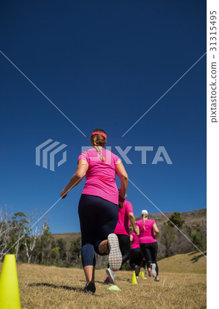 Group of women running through cones in the camp Group of women running through cones in the camp 31315495