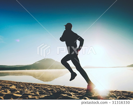 Healthy lifestyle. Man runner running on seaside 31316330