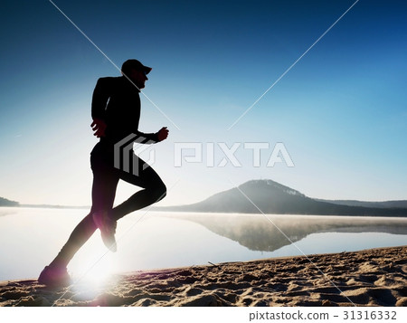 Healthy lifestyle. Man runner running on seaside 31316332