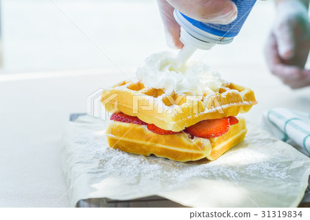 Whipped cream put on belgian waffles 31319834