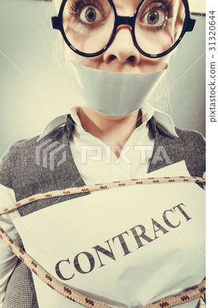 Businesswoman bound by contract with taped mouth. Businesswoman bound by contract with taped mouth. 31320644