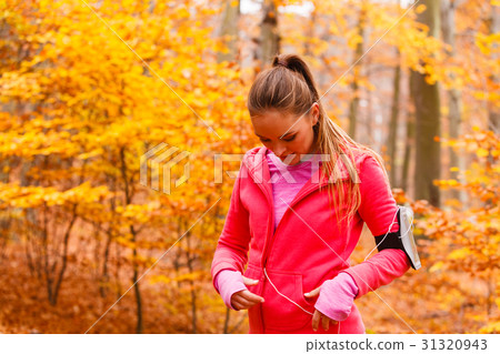 Sporty girl rest in forest listening music. Sporty girl rest in forest listening music. 31320943